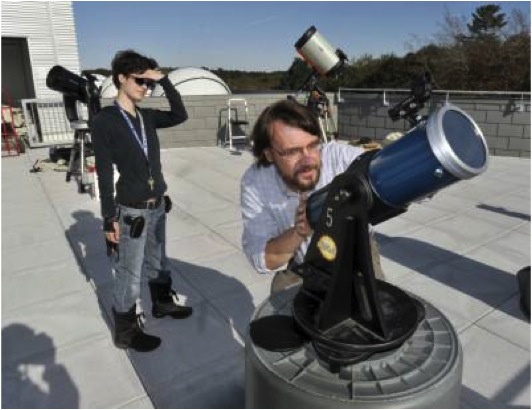 Tony Houser adjusts telescope