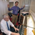 Professor William MacPherson plays the organ as Professor Delvyn Case directs.