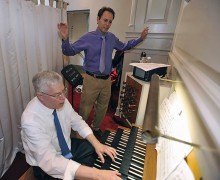 Professor William MacPherson plays the organ as Professor Delvyn Case directs.