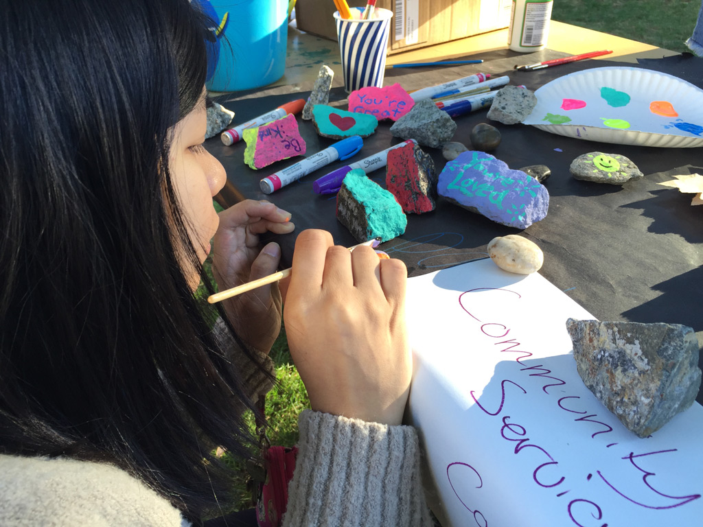 Student painting messages of kindness