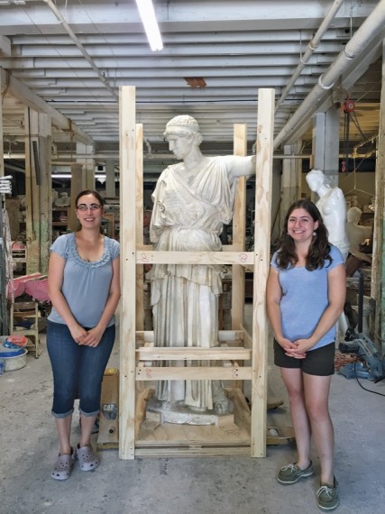 Lisa Shure Benson ’06, left, and Kayla Malouin ’10 stand with Athena at the Giust Gallery.