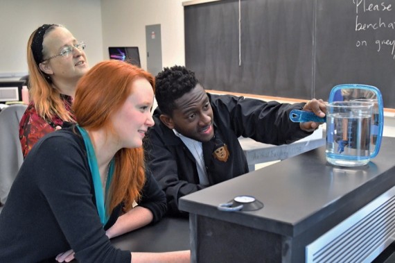Associate Professor of Psychology Kathleen Morgan, Emily Blanchard ’17 and Akrofi Akotiah ’18 observe a betta fish during a lab experiment in 