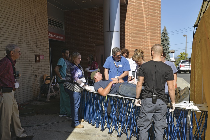 Dr. Michael Weisberg ’93 participates in an emergency preparedness drill at Columbia Memorial Hospital. In the drill scenario, workers from local apple farms needed to be treated for exposure to a toxic pesticide.