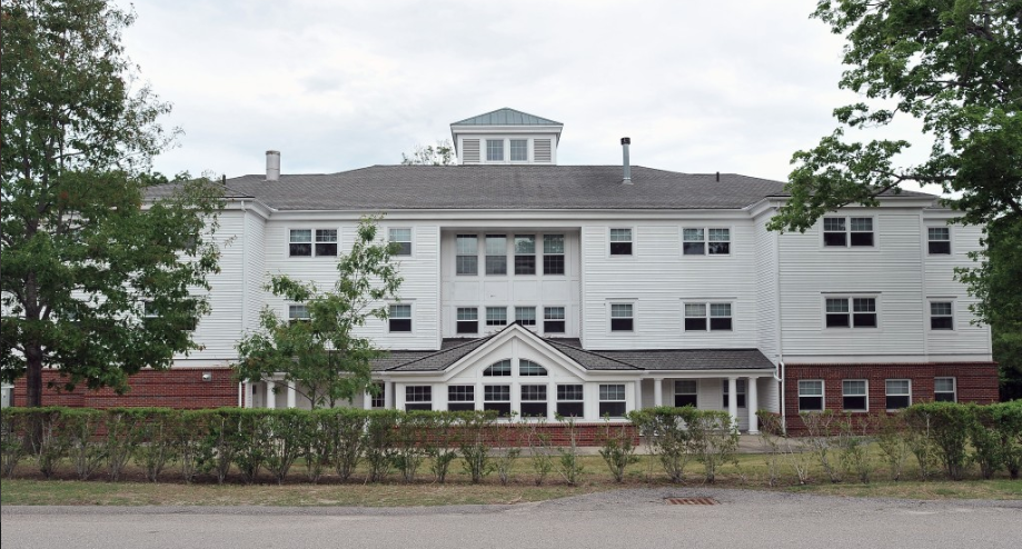 Here is a photo of a white building with numerous windows on it. 