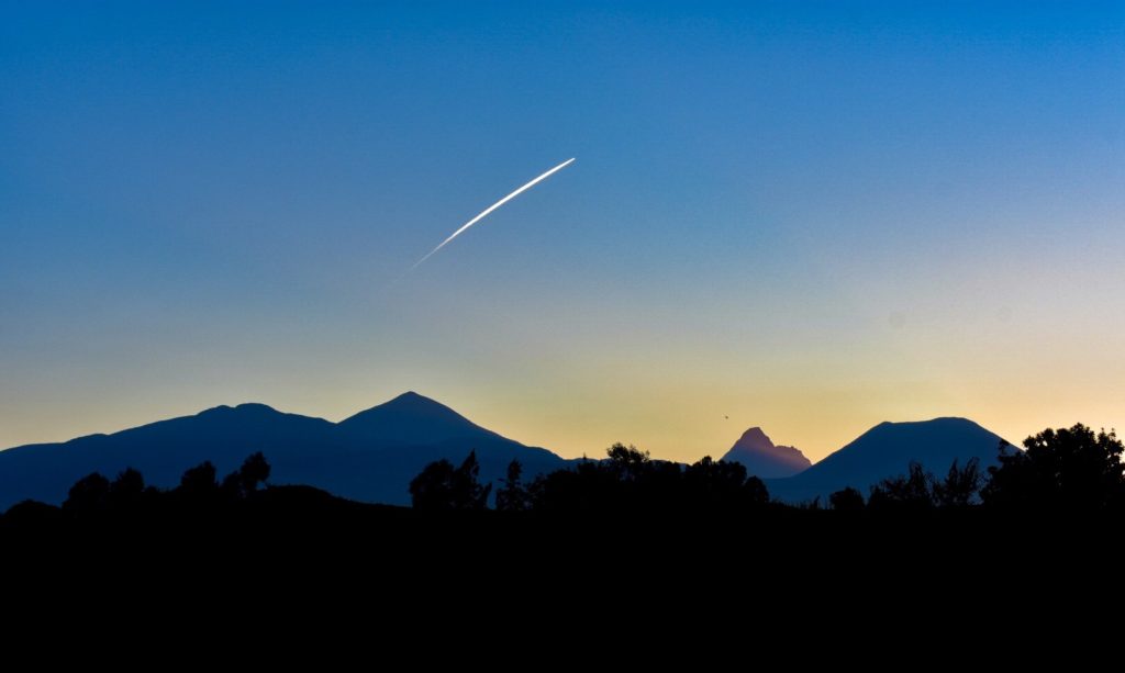 A photo of a shooting star over the mountain range in Rwanda