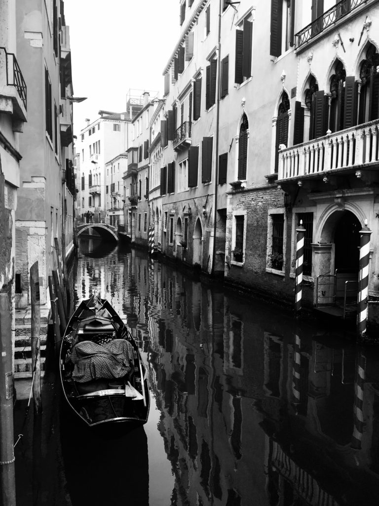 A black and white photo of Venice and its water slowly rising over the years.