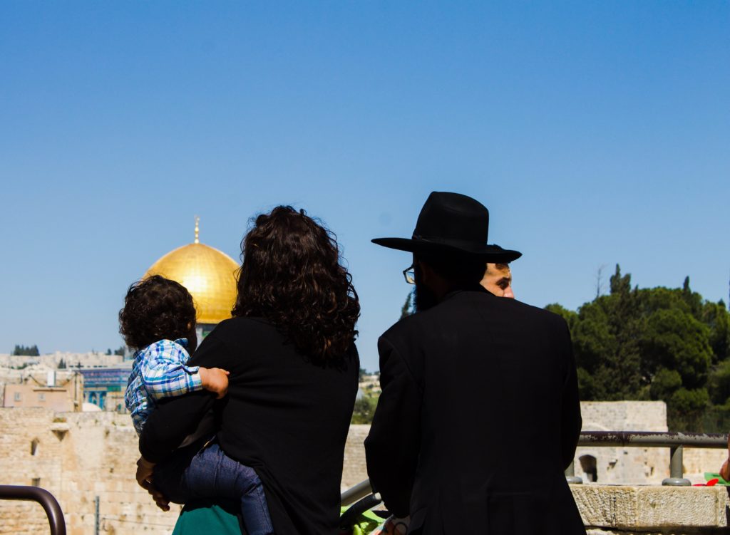 A group photo of a family staring at the Gold Dome in Jerusalem from a distance