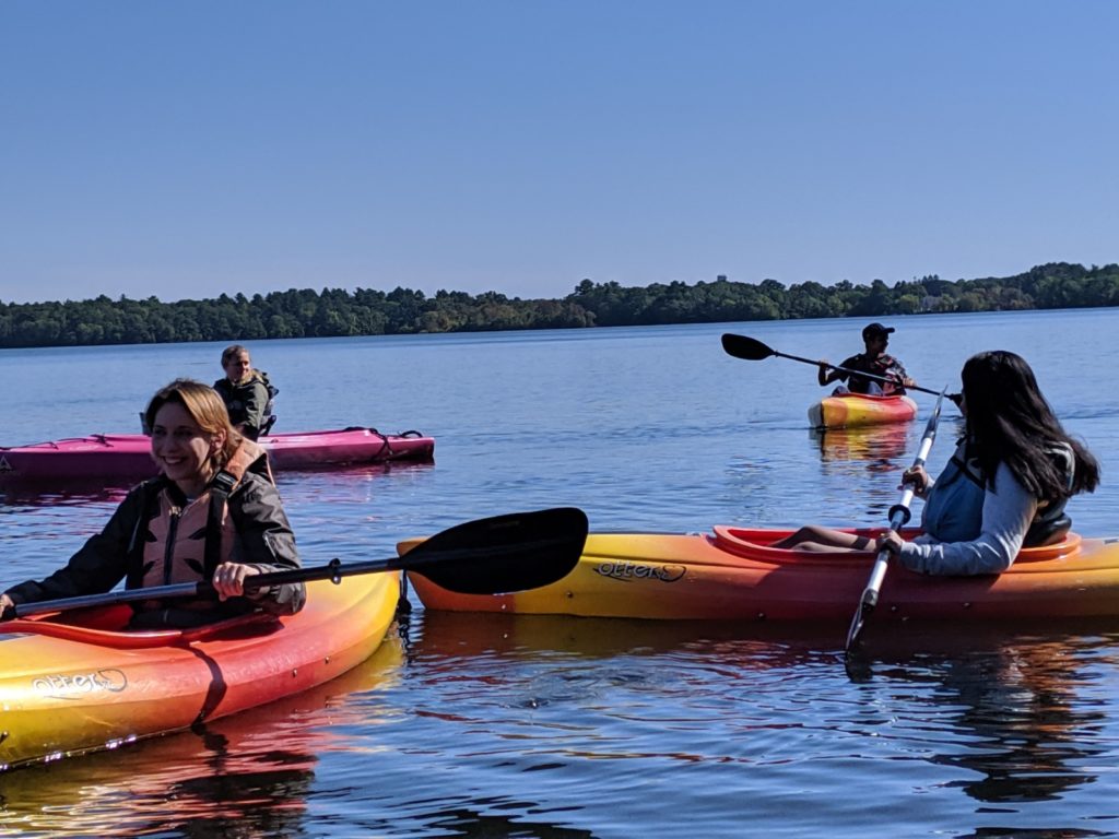 A group of students in the water kayaking