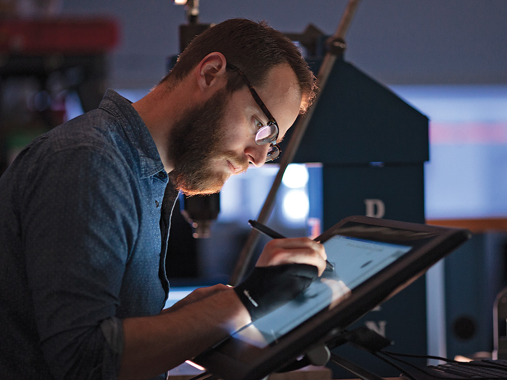 Alex Bandazian ’09 (above, left) digitally sketches a concept vehicle on a tablet.