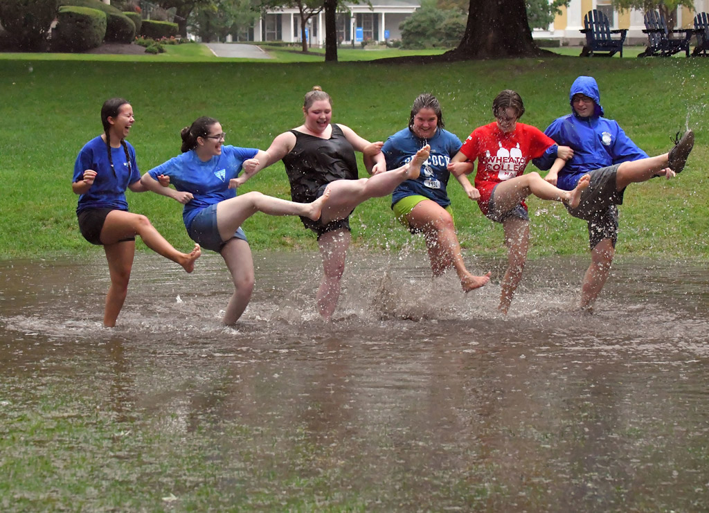 Students splashing in puddle on Dimple