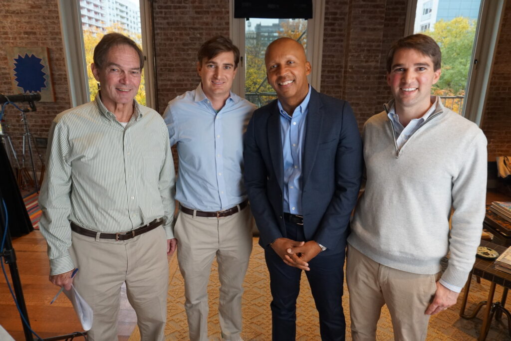 Photo of George Kundhart, Class of 2009, with father, brother and Bryan Bryan Stevenson