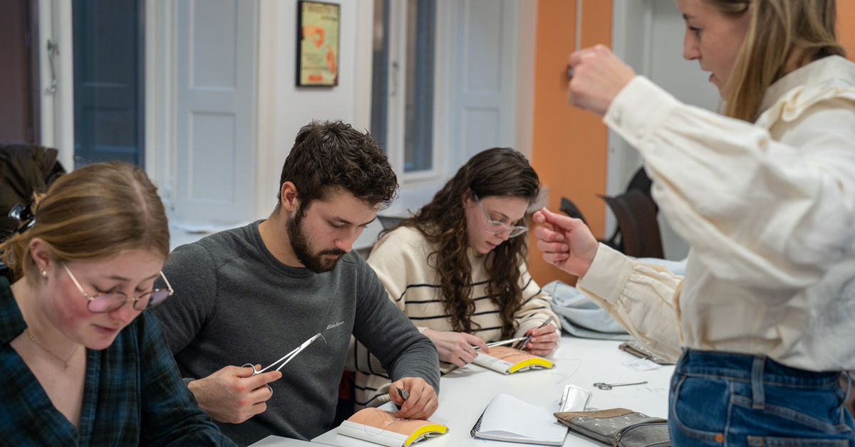 Jackson Elwell practicing suturing technique in Denmark