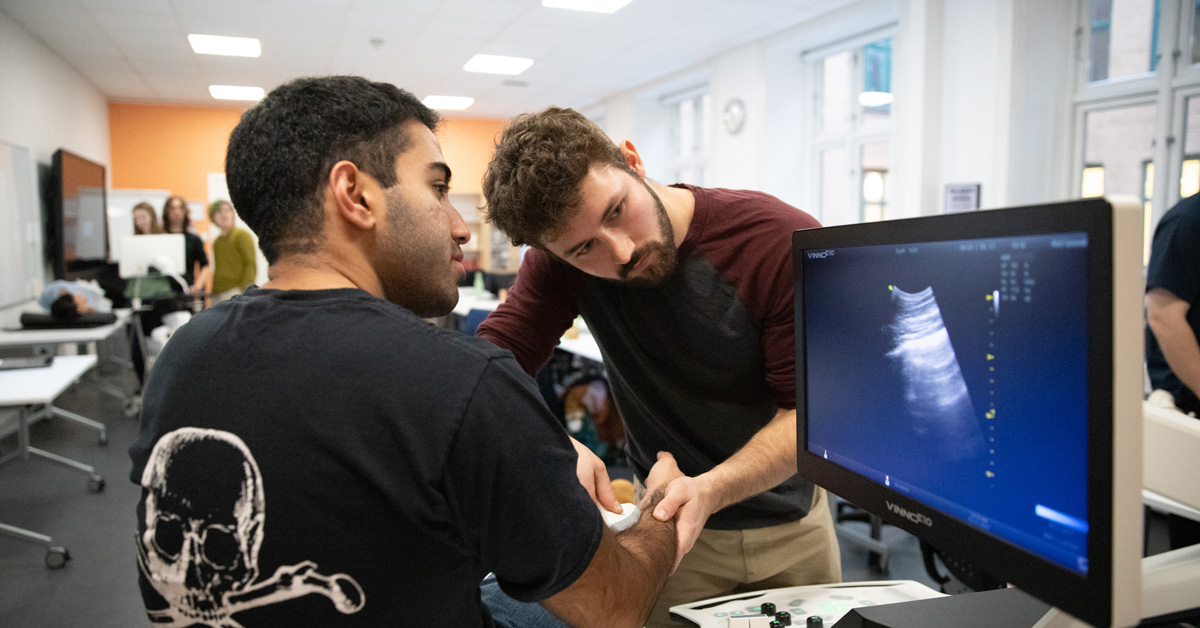 Jackson Elwell working with ultrasound machine