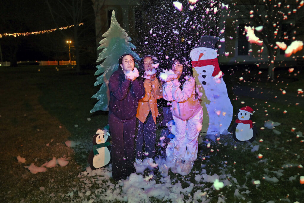 Students in front of snowman display at Winterfest 2023