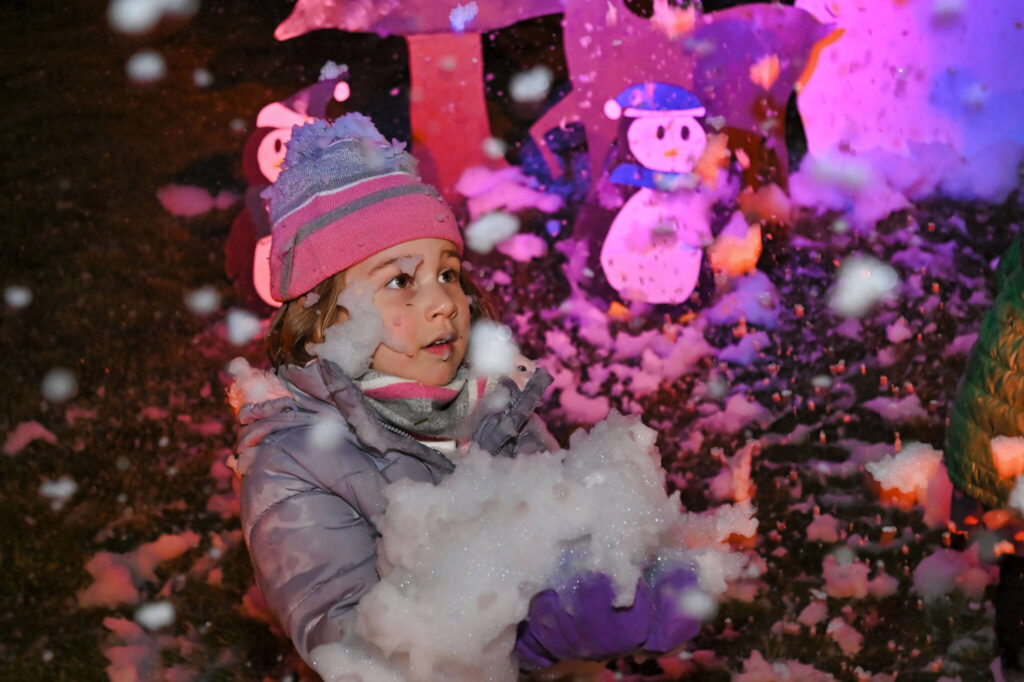 Child holding snow at Winterfest 2023