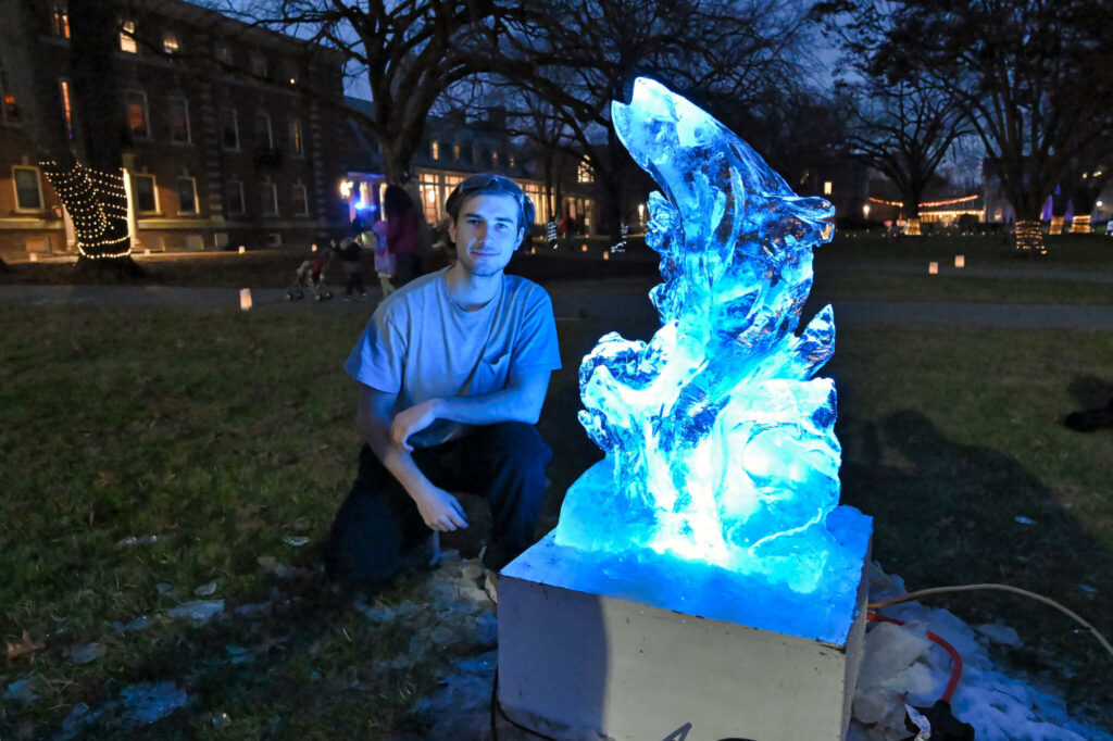 Student with illuminated ice sculpture at Winterfest 2023