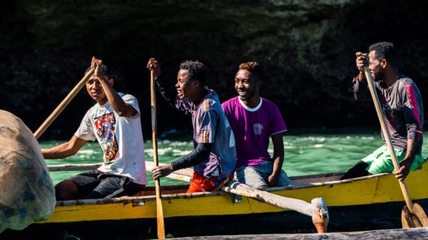 Four men rowing a boat.