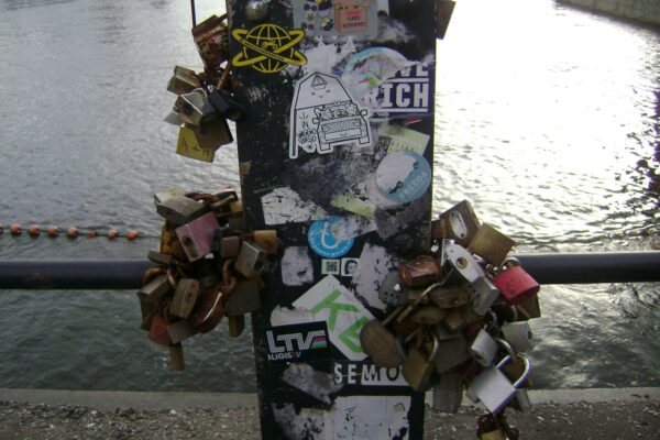 Close up shot of locks attached to a bridge.