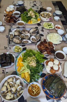 Long table filled with Vietnamese food.