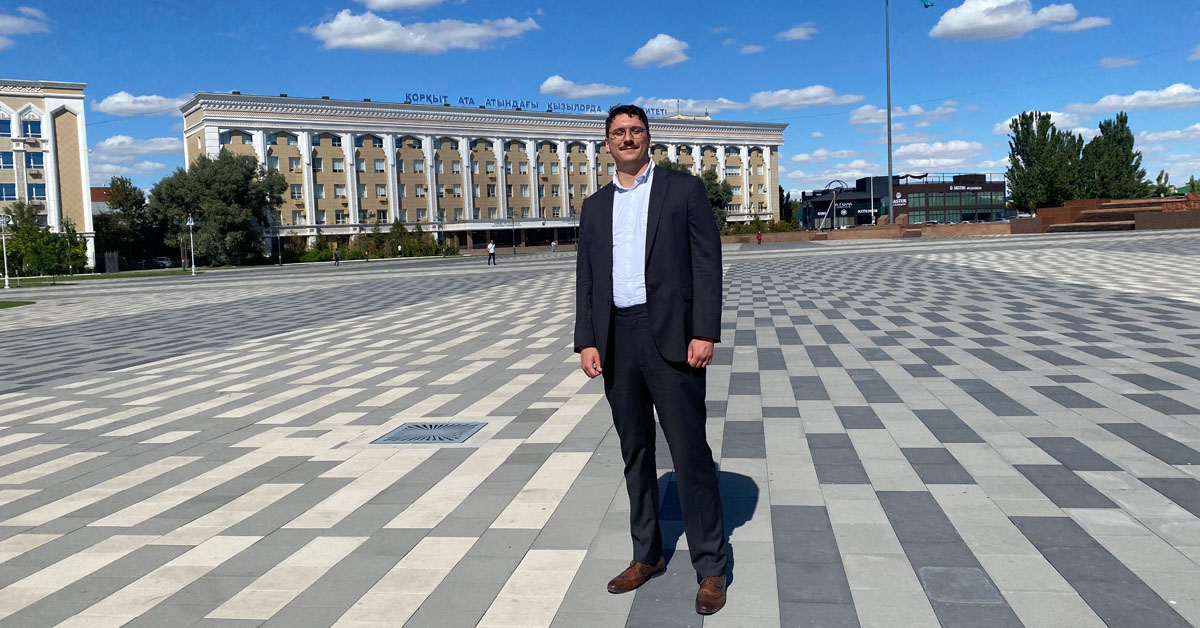 Emile Bautista-Bekken stands in front of a university building.