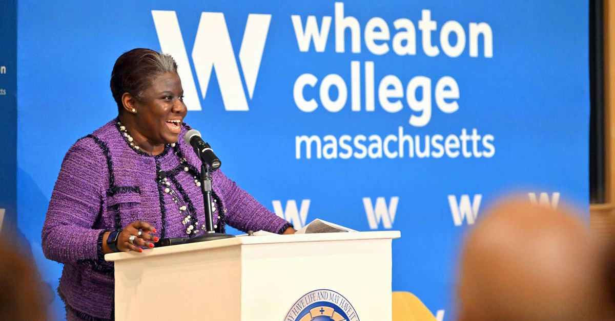 Indira Henard '03 speaks at a podium.