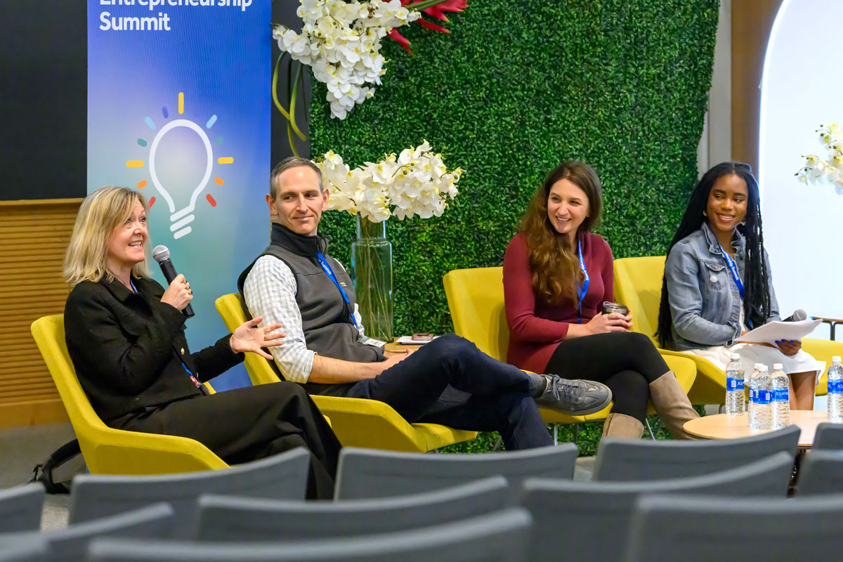 Two professionals and two students seated at the Entrepreneurship Summit
