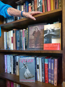 A collection of books on a shelf.