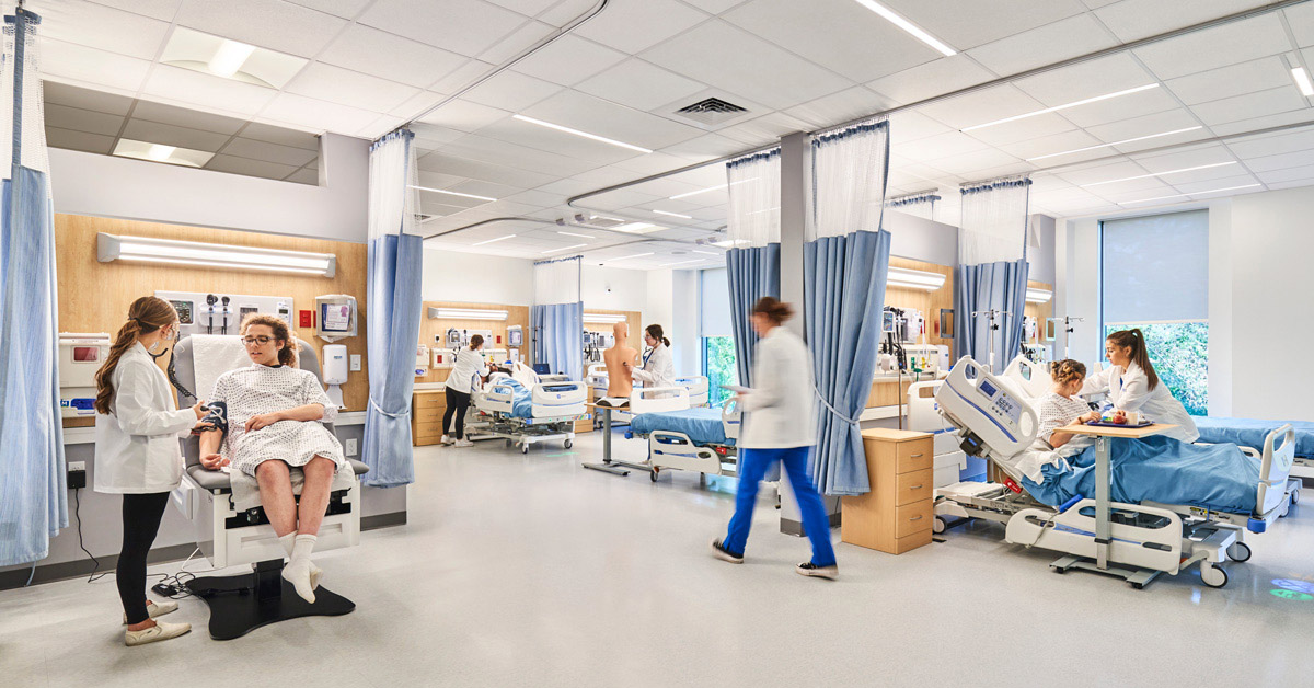 Student nurses tend to patients in a simulated lab.
