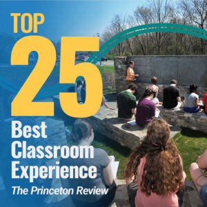 Students sit outside on stone benches, listening to a an instructor in front of the class. Text on the image reads Top 25 best classroom experience The Princeton Review.