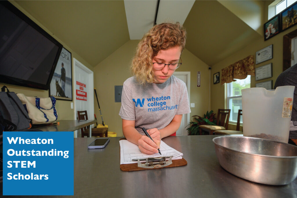 WOSS student recording data in a lab notebook.