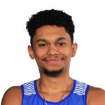 A smiling man with short black hair wearing a blue and white athletic tank top