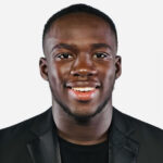 A smiling man wearing a black shirt and black sportcoat