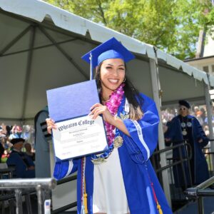 Micaela Luffborough shows offer her diploma after receiving it.