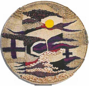 Circular woven fiber artwork featuring an abstract landscape design with a yellow sun, dark mountainous shapes, waves, and cross motifs in beige, purple, and black tones.